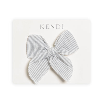A close-up image of a mist-colored Baby Seersucker Bow Clip, perfect for accessorizing infant and toddler hair